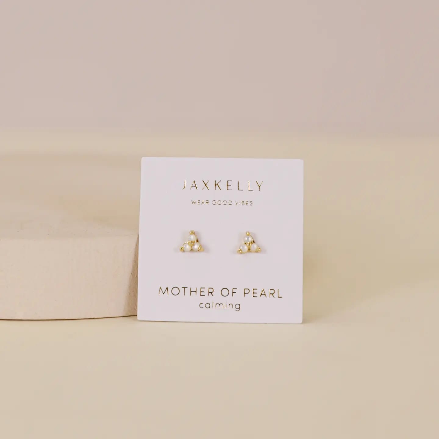 Jaxkelly earrings on a white card with 'Mother of Pearl' text on a beige background -yenology