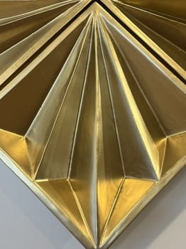Close-up of a gold geometric design on a white background