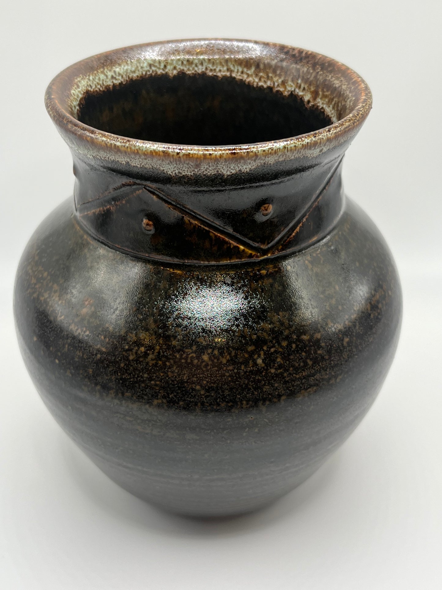 Black ceramic vase on a white background