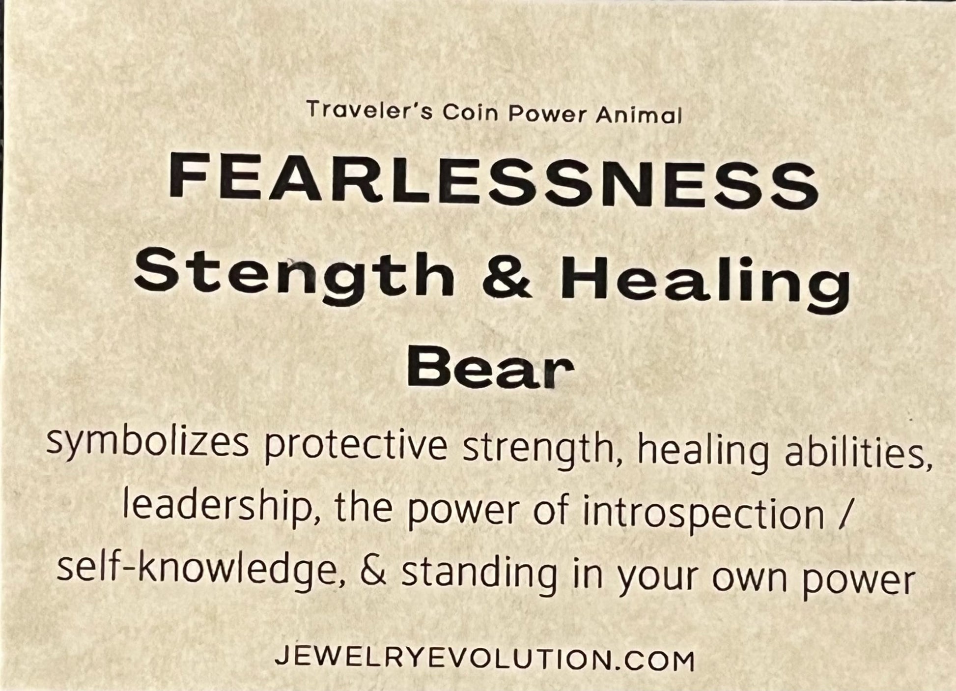 Text on a beige background describing the symbolism of fearlessness, strength, and healing associated with a bear. Includes a website reference.