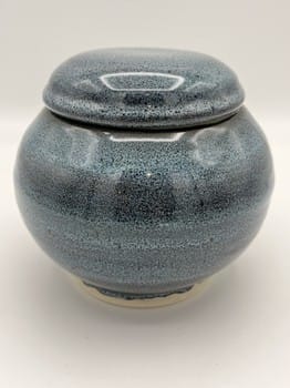 Blue ceramic jar with a lid on a white background