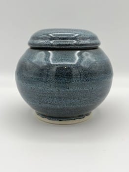 Blue ceramic jar with a lid on a white background