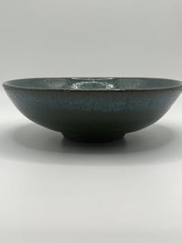 Dark ceramic bowl on a light gray background