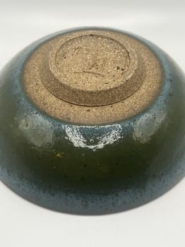 Ceramic bowl with a textured surface on a white background