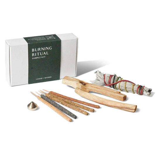 Burning Ritual sample kit with incense sticks, wooden tools, and sage on a white background