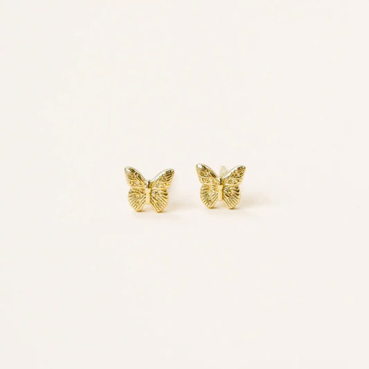 Gold butterfly earrings on a white background