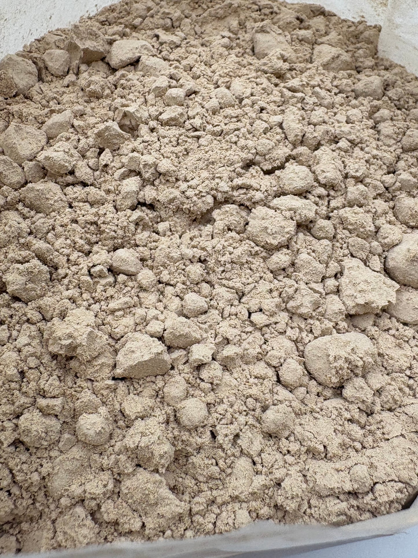 Close-up of Acorus calamus powder showing fine texture and warm golden tone.