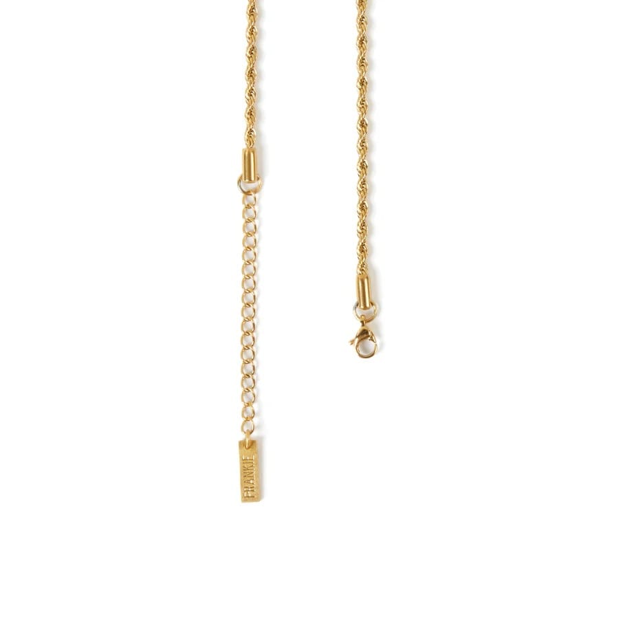 Gold necklace with a small tag on a white background