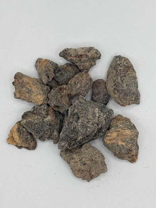 Close-up of Boswellia neglecta resin showing golden and dark hues.