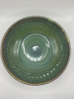 Green ceramic bowl on a white background