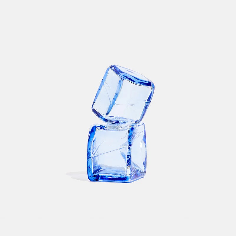 Two blue glass cubes stacked on a light gray background