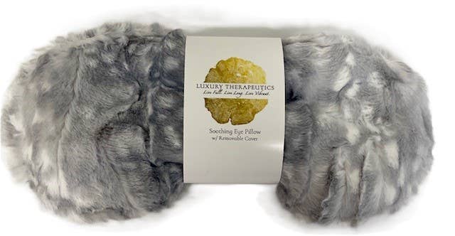Gray eye pillow with a label on a white background