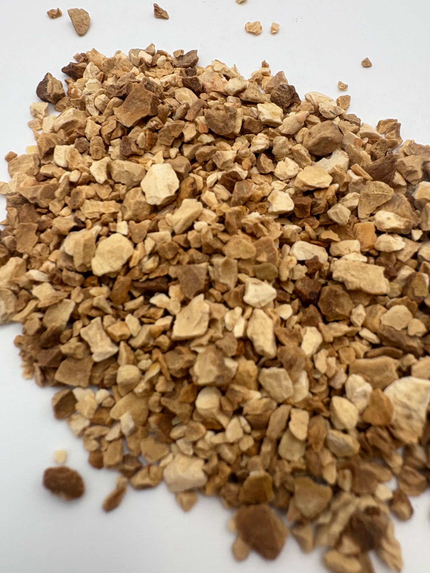 Close-up of French orris root pieces showing natural beige texture.