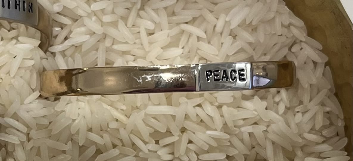 Silver cuff bracelet with 'PEACE' engraving