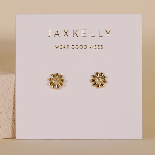 Gold flower-shaped earrings on a Jaxkelly branded card with 'Wear Good Vibes' text.