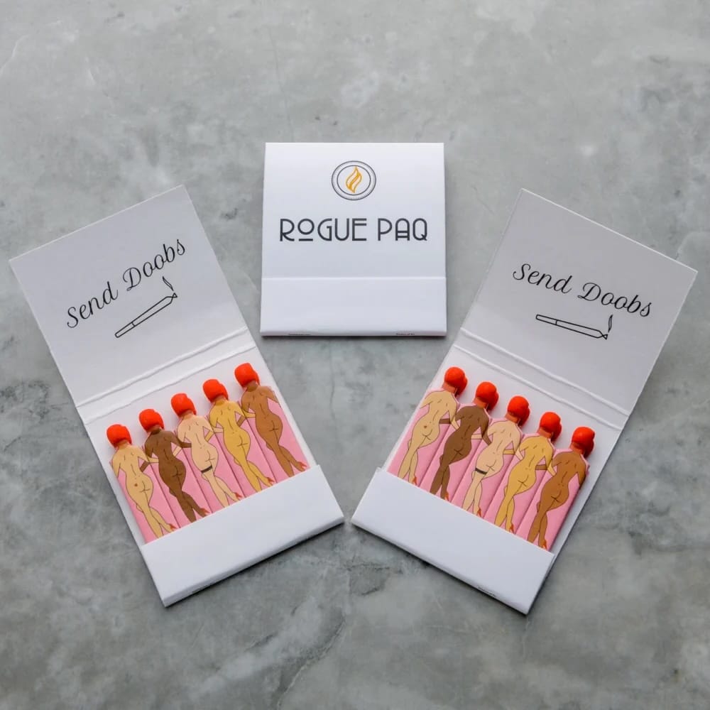 Two open boxes of 'Send Doobs' with illustrations of women and 'Rogue Paq' branding.