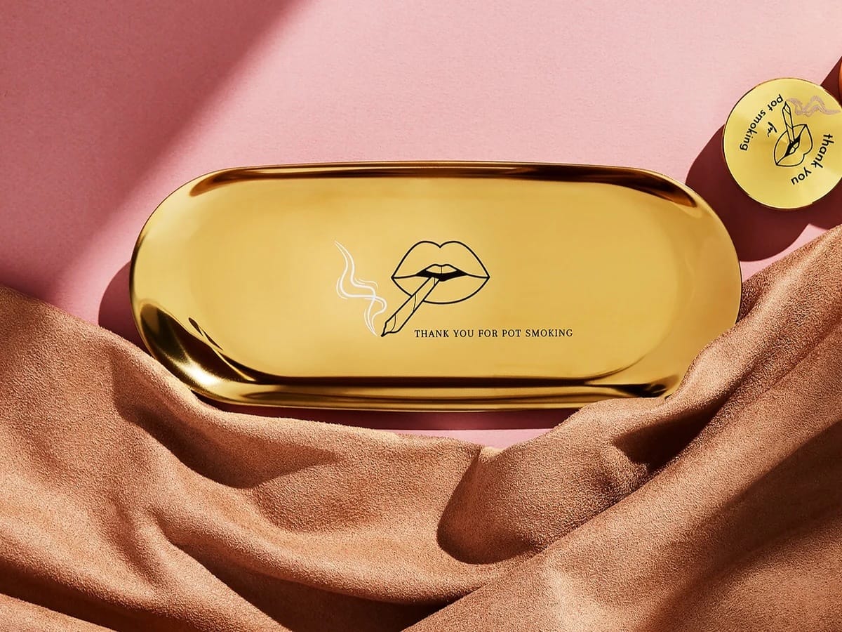 Rogue Paq gold rolling tray
Stainless steel joint tray
“Thank You for Pot Smoking” tray
Gold cannabis accessories
Travel rolling tray with bag
Designer rolling tray lips graphic
Slim metal joint tray
Elegant weed rolling surface
Stylish cannabis gift
Portable gold-toned tray
