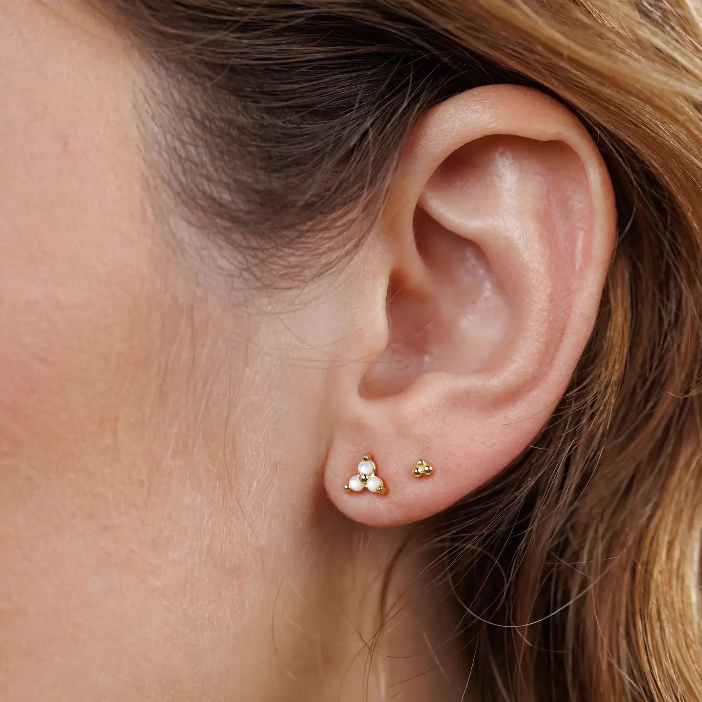 Close-up of an ear wearing jax kelly trio stud on model