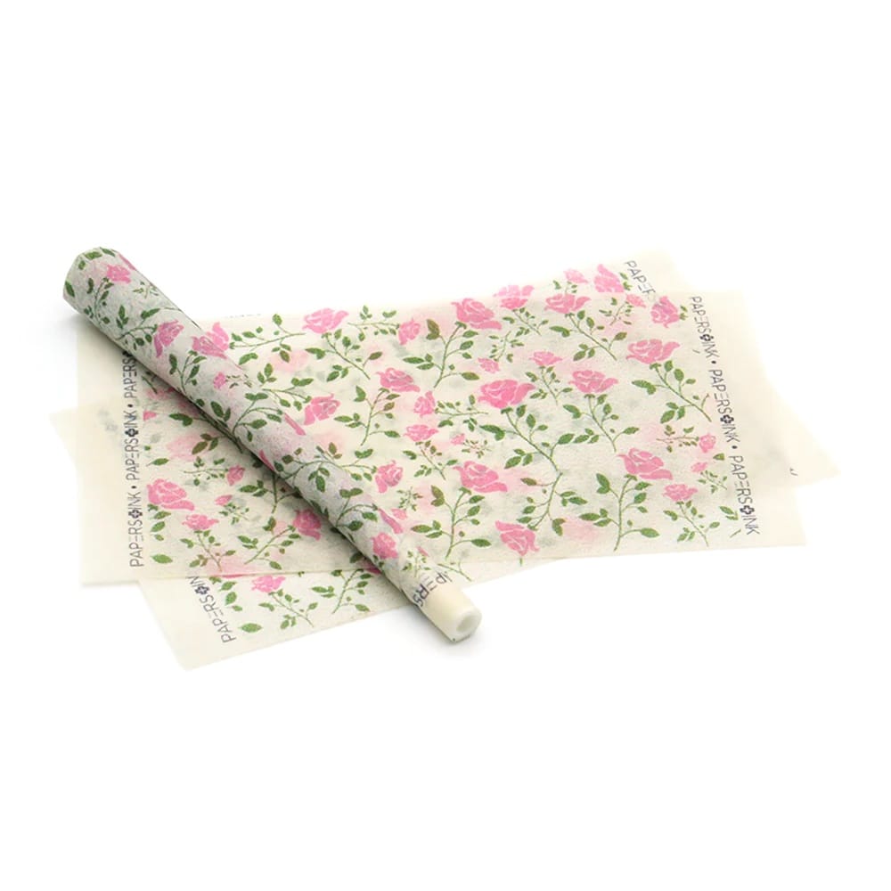 Roll of floral-patterned paper on a white background