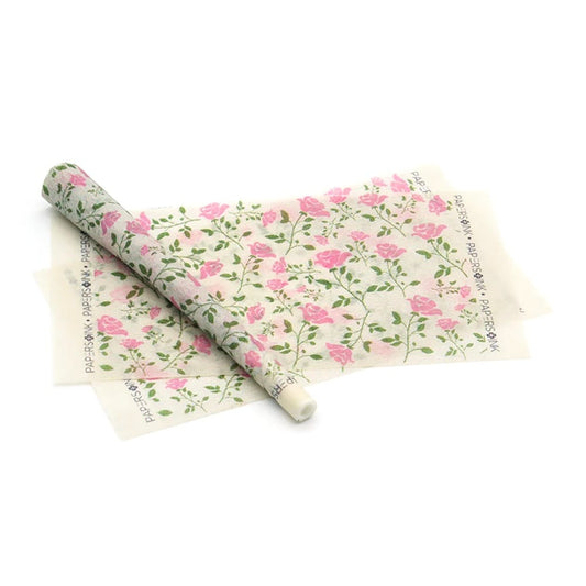 Roll of floral-patterned paper on a white background