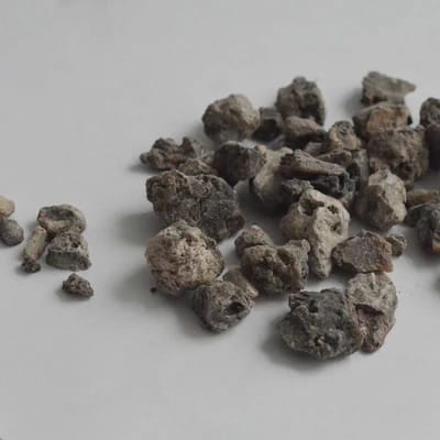 Close-up of natural Black Copal resin pieces showcasing their dark, glossy texture and earthy tone.