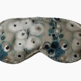 Lavender-scented teal eye pillow with removable watercolor fabric cover.