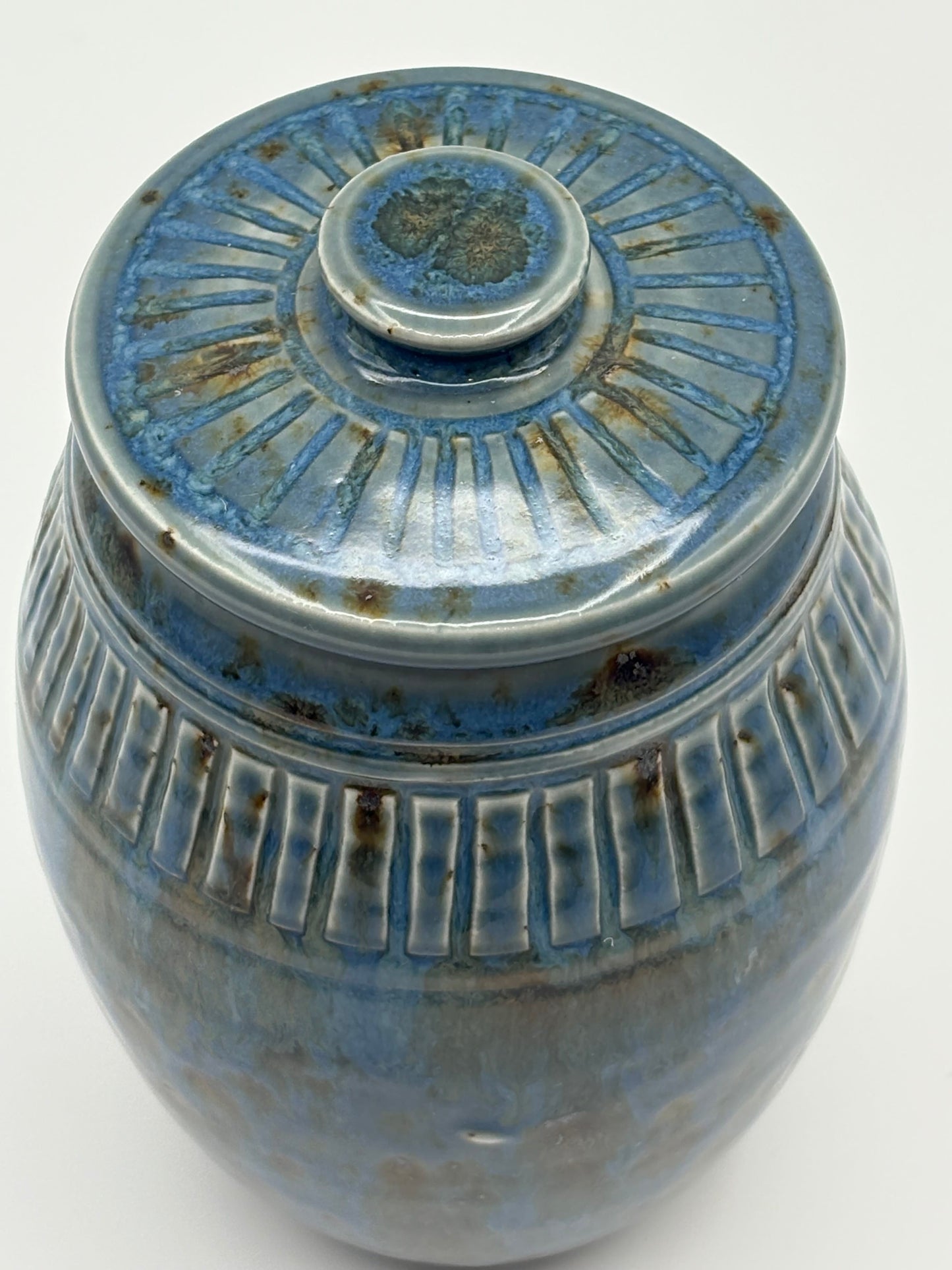Blue ceramic jar with textured surface 