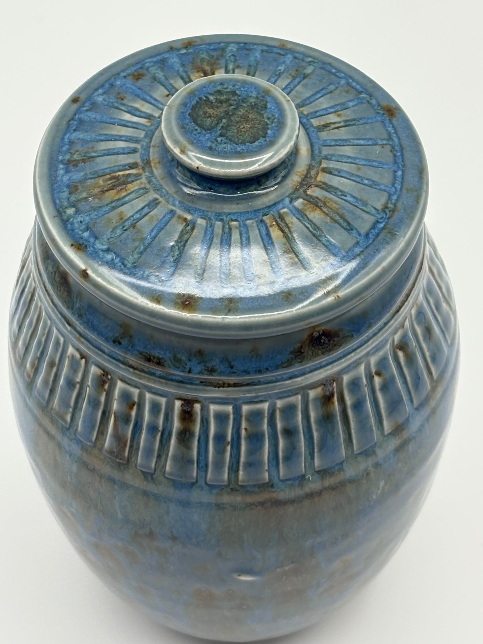 Blue ceramic jar with textured surface 