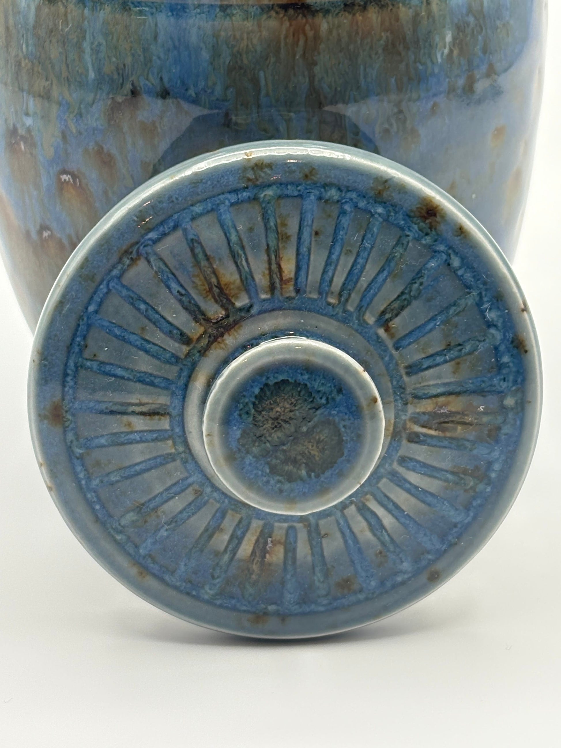 Close-up of a blue ceramic vase with textured surface 