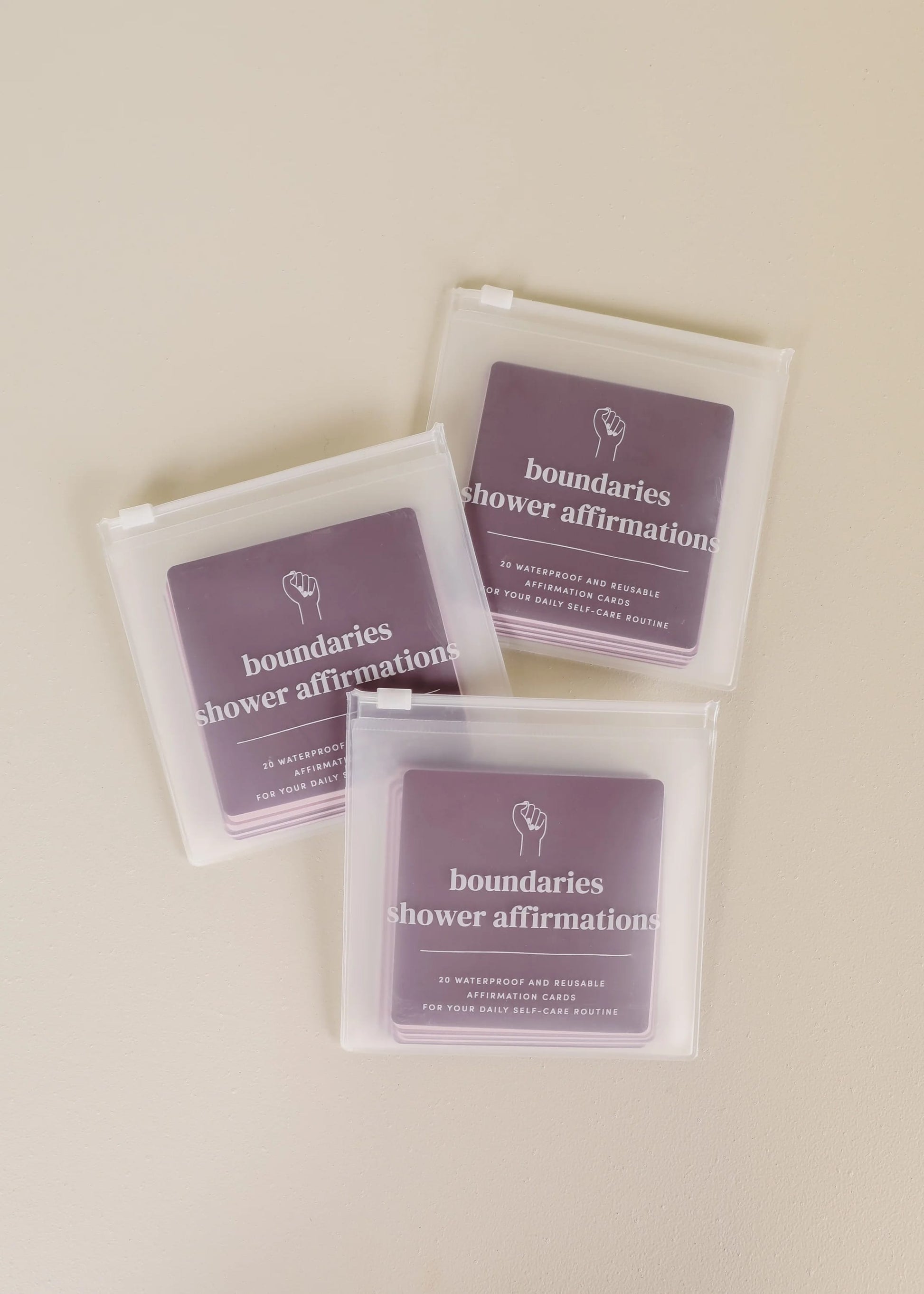 Three packages of 'boundaries shower affirmations' on a beige background