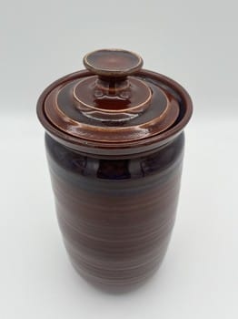 Ceramic jar with a lid on a white background