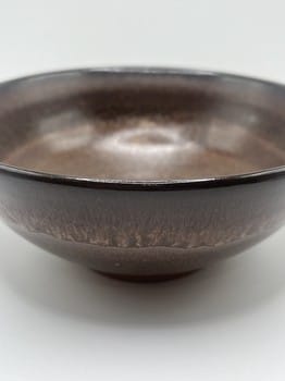 Brown ceramic bowl on a white background