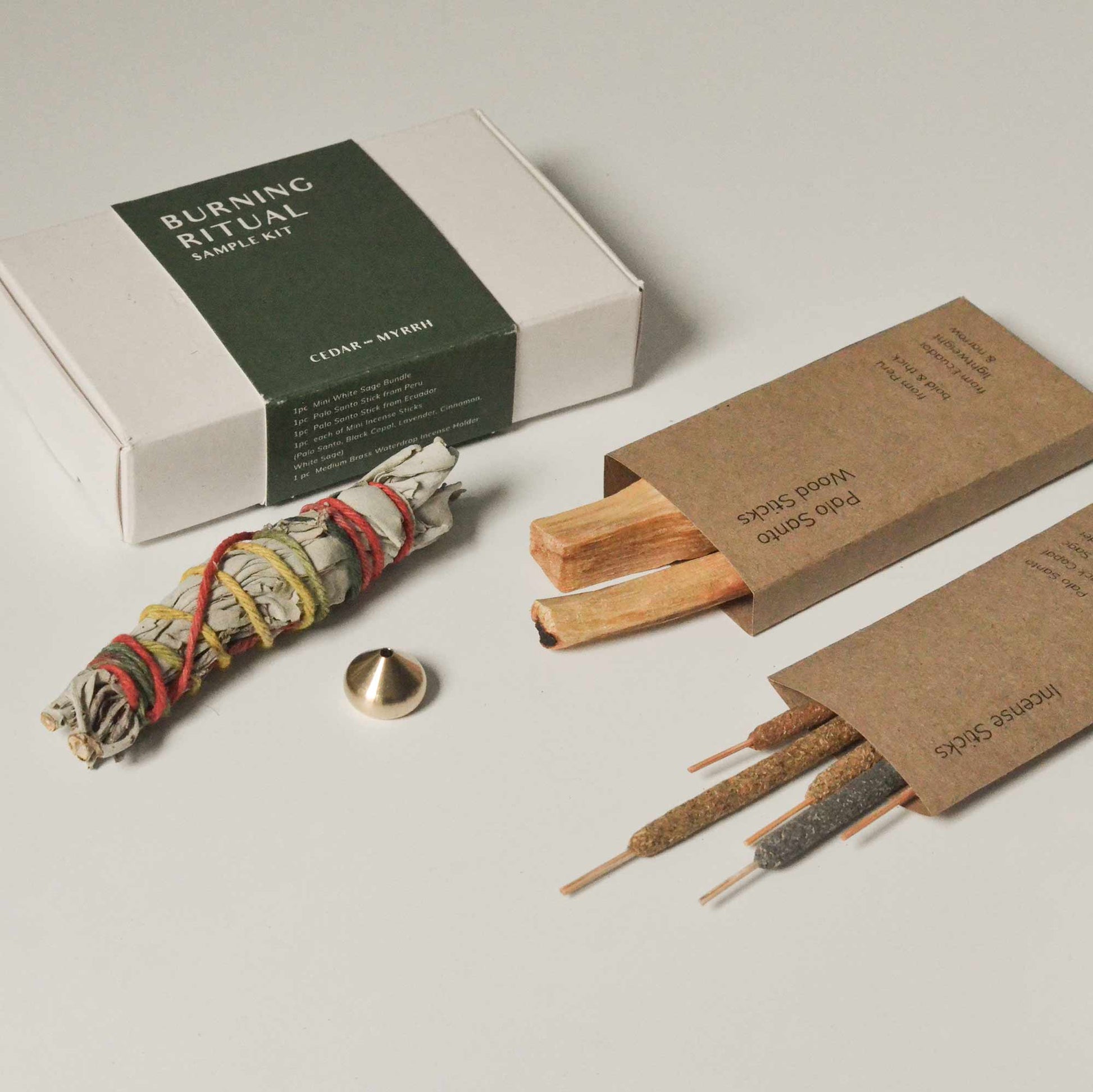 Burning Ritual Sample Kit featuring Palo Santo, sage bundle, incense, and holder.