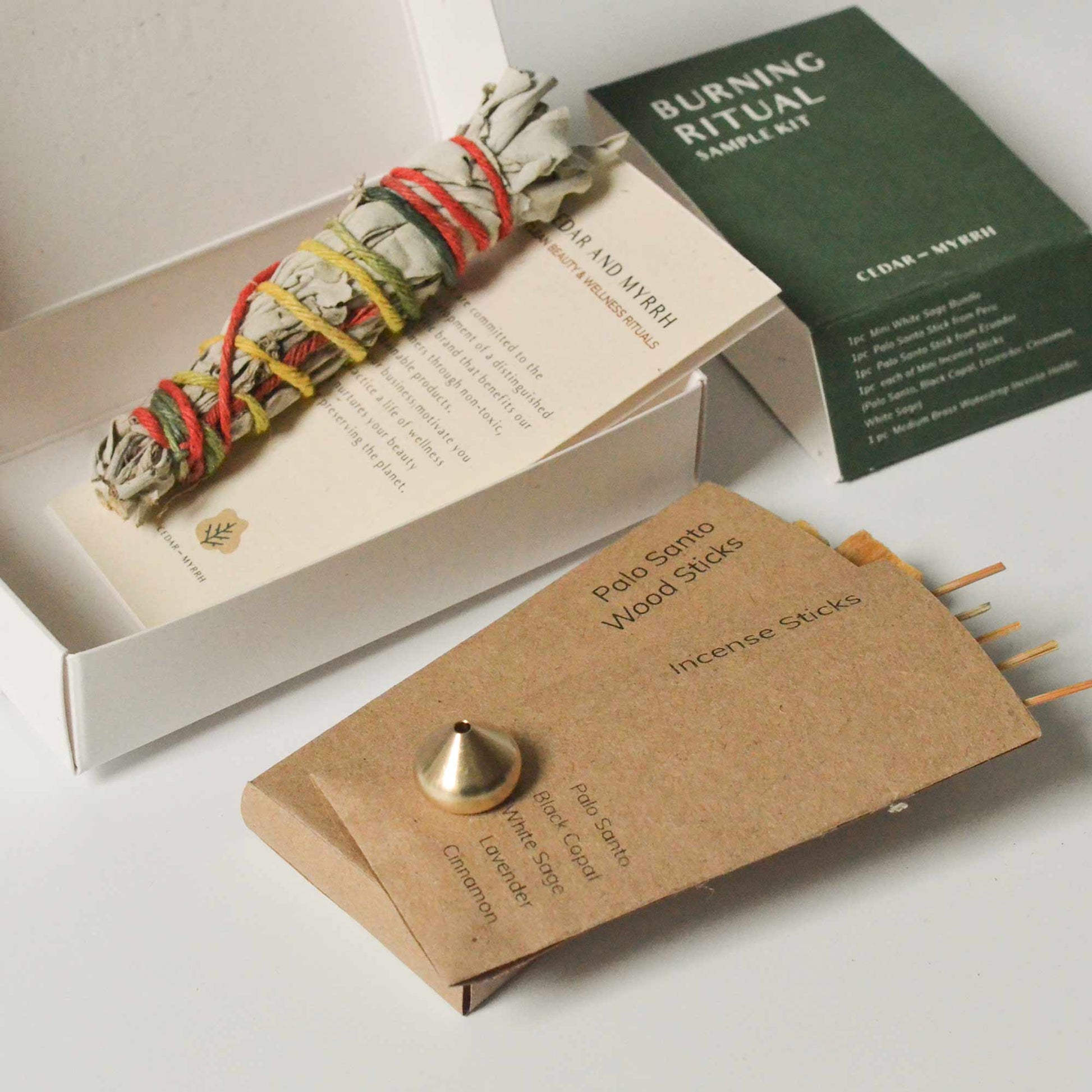 Burning Ritual sample kit with sage bundle, incense sticks, and packaging on a white background