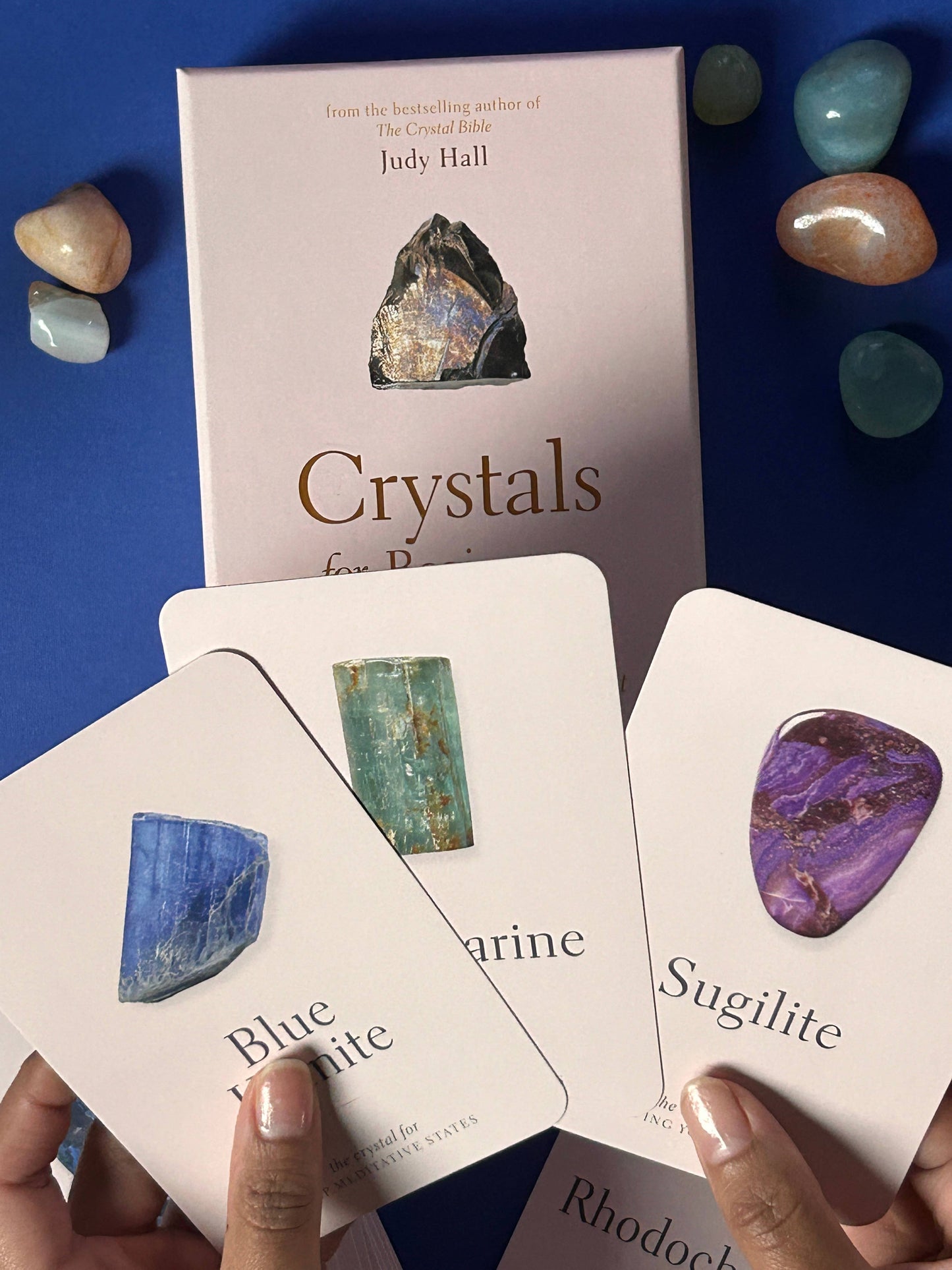 Cards with crystal cards and a book titled 'Crystals' on a blue background with crystals.