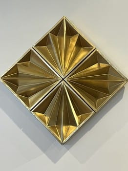Gold geometric wall art on a white background
