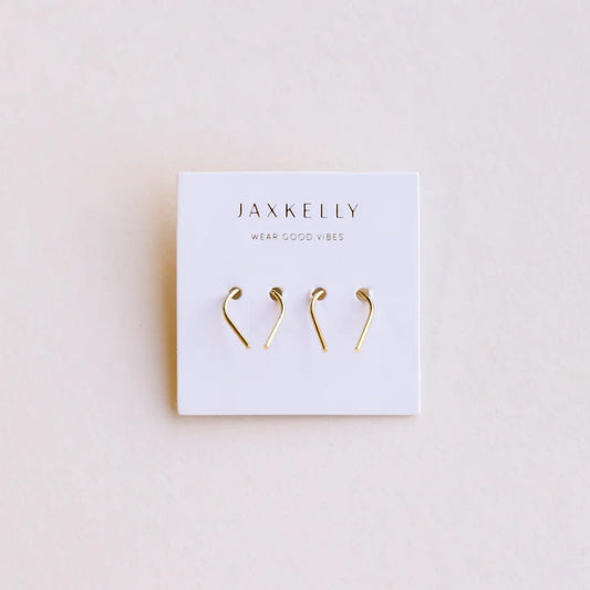 Gold earrings on a Jaxkelly branded card against a beige background