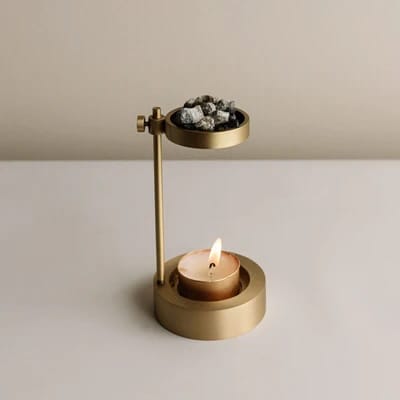 Brass Incense Holder displayed beside candles and meditation decor.