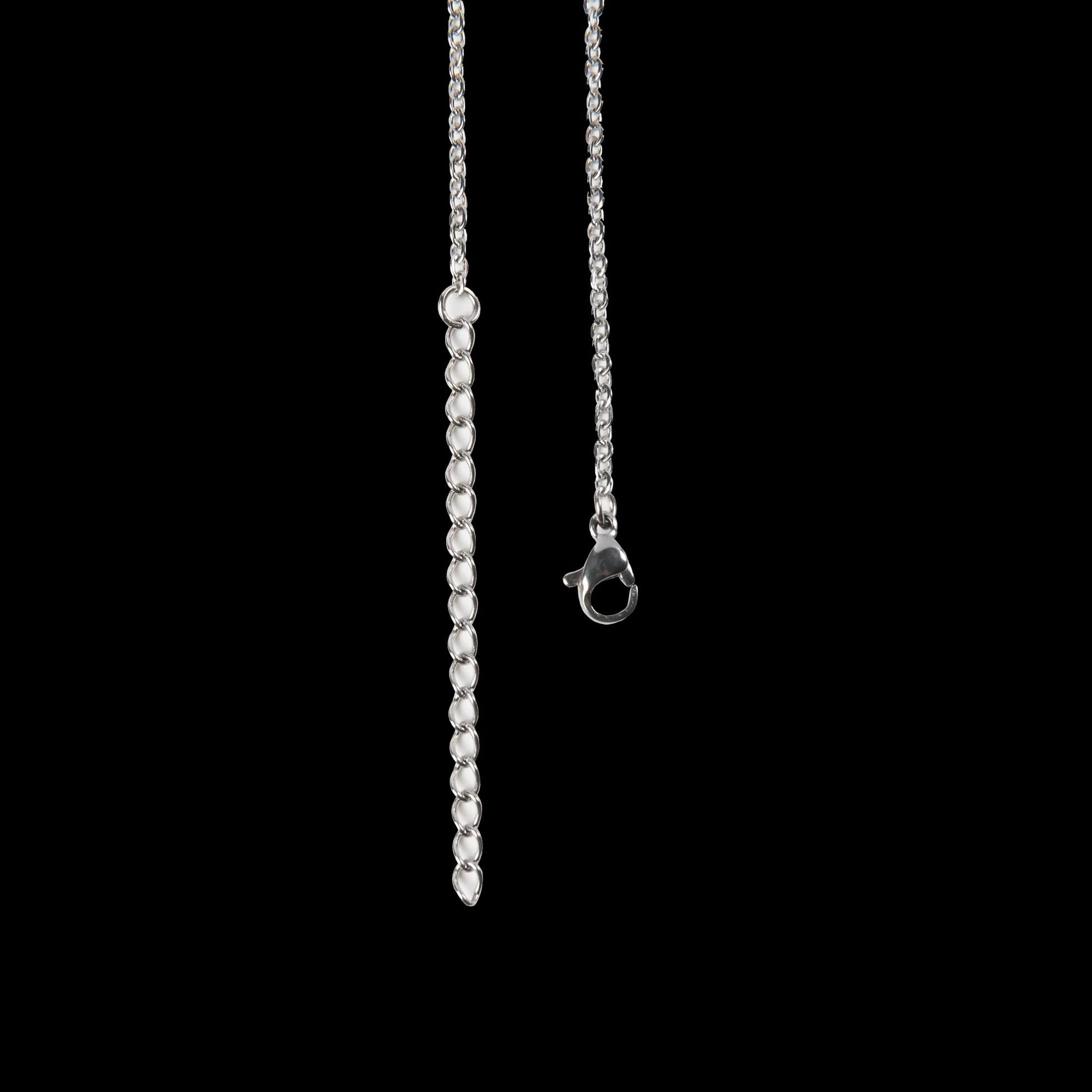 Silver necklace with a beaded chain on a black background