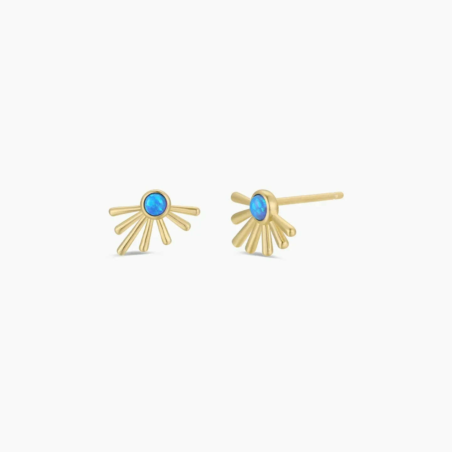 Gold earrings with turquoise stones on a white background