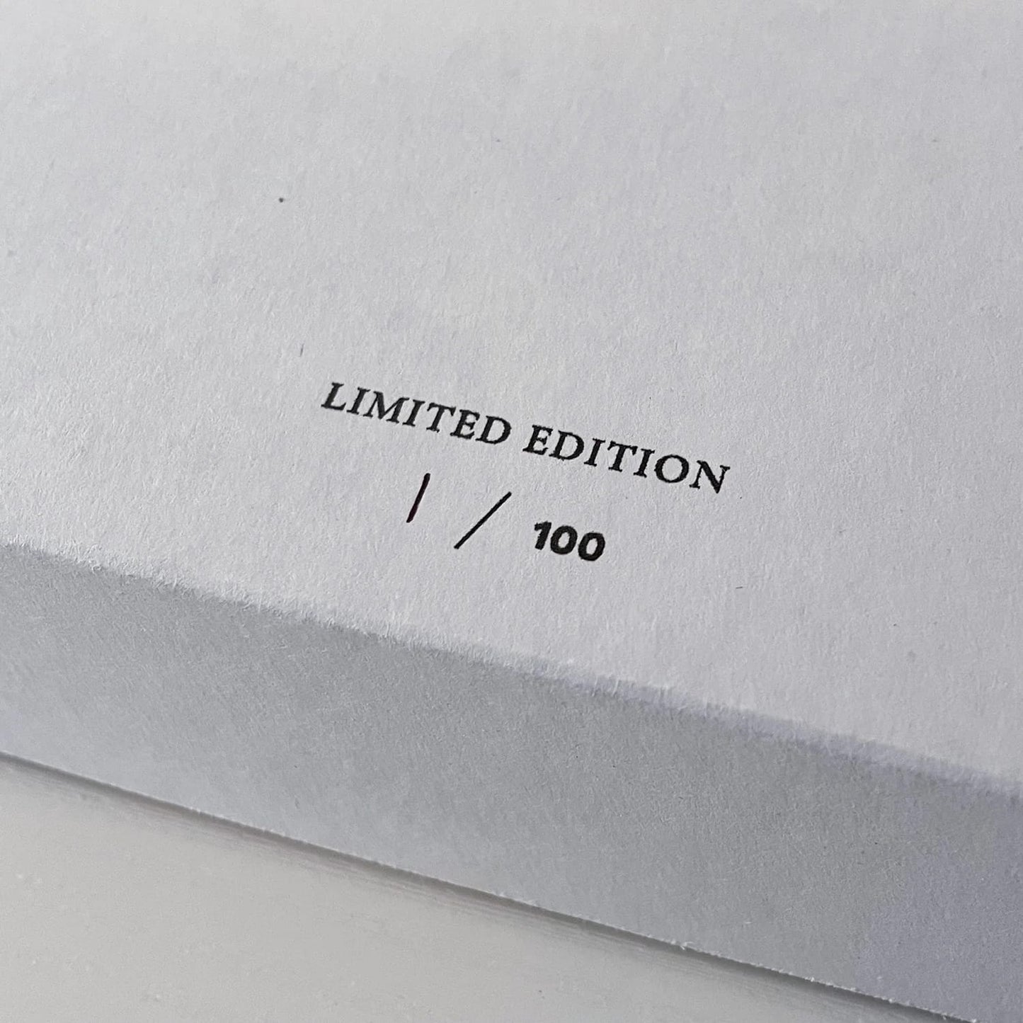 Limited edition stamp on a gray surface